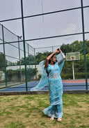 aqua green chiffon saree with white leaf print, model stylish posing