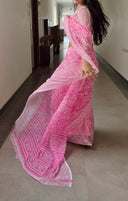 pink chiffon saree with white leaf print, model walking outdoors saree detail
