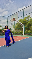 Blue chiffon leheriya saree with gold border, model Posing outdoors