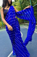 Blue chiffon leheriya saree with gold border, model showing saree