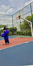 Blue chiffon leheriya saree with gold border, model dancing outdoors