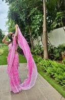 pink chiffon saree with white leaf print, model walking outdoors pallu shot