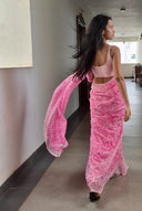 pink chiffon saree with white leaf print, model walking outdoors Back profile
