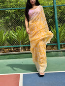 Sea green chiffon saree with white leaf print, model walking outdoors On basketball ground